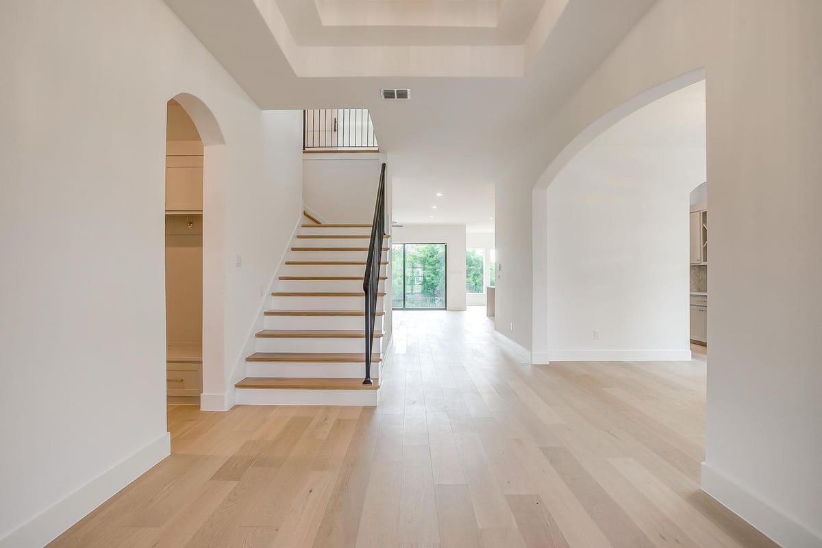 Entry hall with an open stair and wide plank flooring