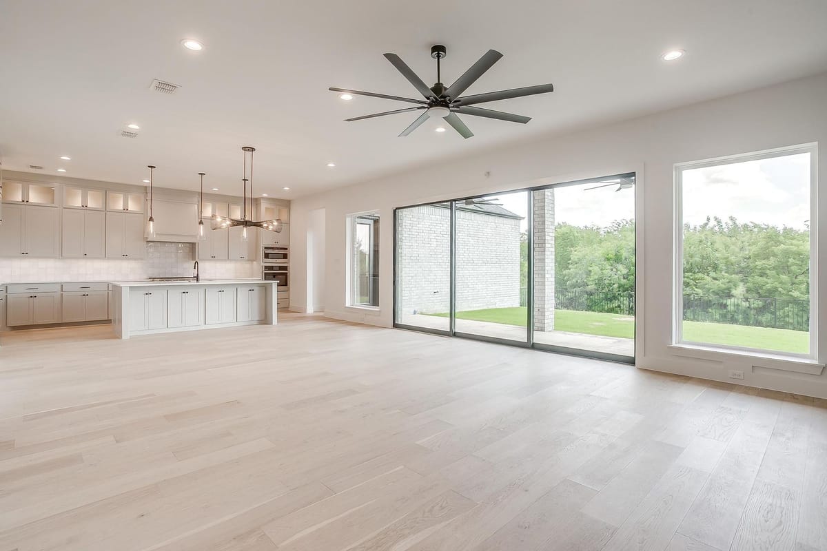 Open plan kitchen and living room with sliding glass doors to the yard