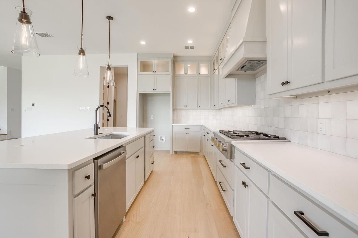 Kitchen with a working sink island and a walk-through to the dining area
