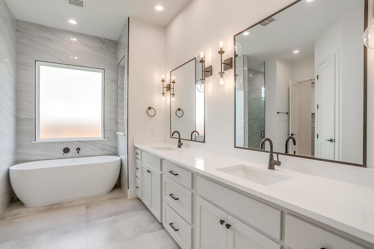 Primary bathroom in a Parkwood custom home with a freestanding tub and a long double vanity