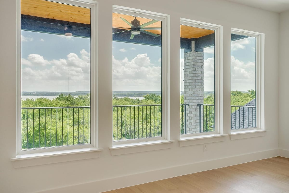 Bank of windows in a Parkwood custom home looking out over open country