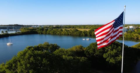 An American flag on a flagpole waving in the wind